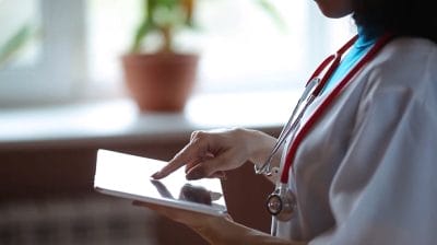 Doctor using a tablet in a clinical setting