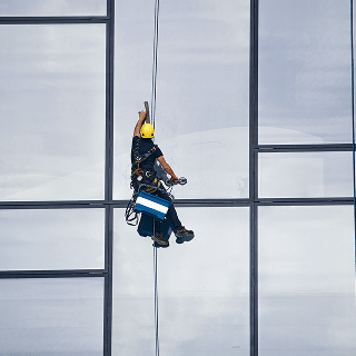 worker-hanging-off-buidling
